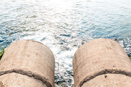 Unclean water from the sewer flows into the river.の写真素材