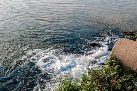 Unclean water from the sewer flows into the river.の写真素材