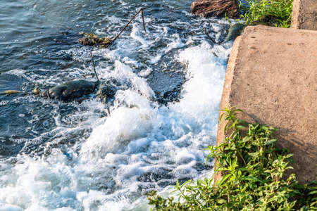 Unclean water from the sewer flows into the river.の写真素材
