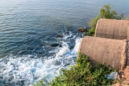 Unclean water from the sewer flows into the river.