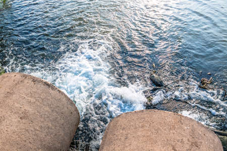 Unclean water from the sewer flows into the river.の写真素材