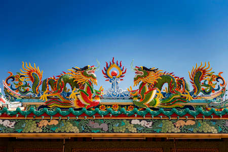 colorful dragon statue on the roof Chinese temple in Tak Province ,Thailandの写真素材
