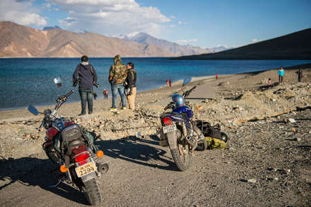 LADAKH ,INDIA - SEPTEMBER 2014 : Caravan roadtrip travelers at Pangong Lake,Pangong Lake is an endorheic lake in the Himalayas situated at a height of about 4,350 m (14,270 ft). It is 134 km (83 mi) long and extends from India to Tibet.のeditorial素材