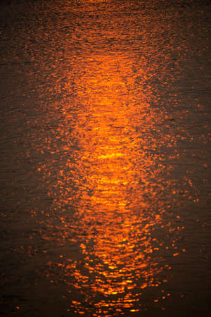 Blurred background of bokeh light at sunset from the river.の写真素材