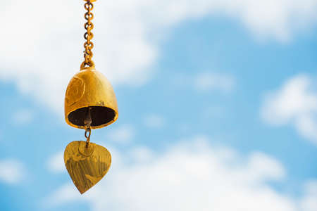 Small gold color of buddhist bell in the temple and blue sky ,Thailand.の写真素材