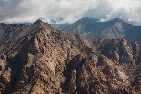 Aerial view of desert and high mountain from the airplane window. New Delhi-Leh flight ,India.