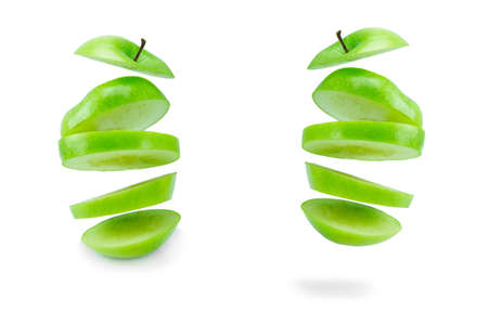 floating sliced of green apple isolated on a white background.の写真素材