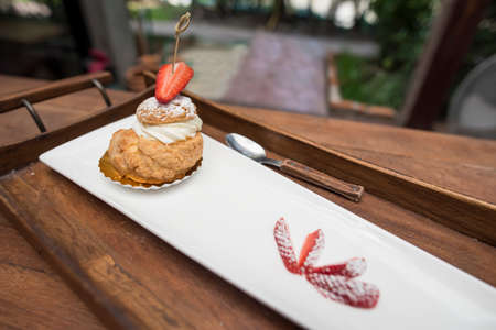 fresh strawberry Choux Cream on wooden tray.