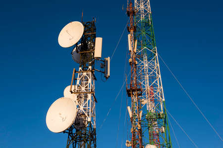 Telecommunications tower at sunrise and blue sky.