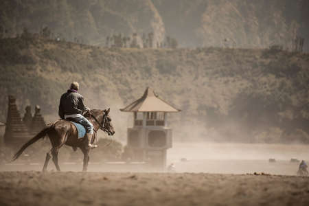 Horse rider on desert near Bromo Mountain Java ,Indonesia.の写真素材