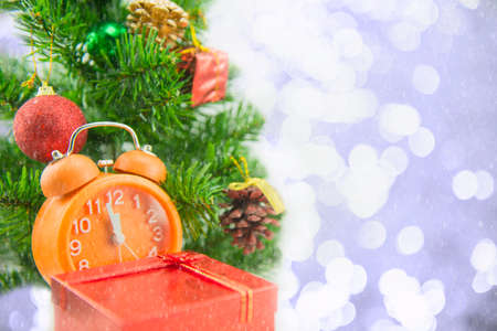 Christmas present celebration time orange clock and christmas tree.