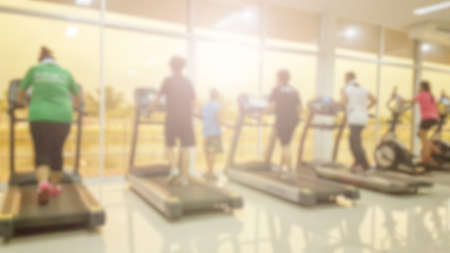 Blurred of fitness gym and group of prople running on treadmills.16:9の写真素材
