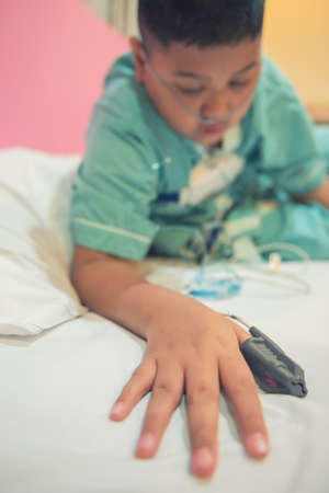 Asian boy wearing Sleep Apnea Diagnostic medical device Kit. Sleep Lab Test.の写真素材