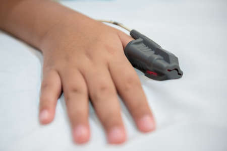 Hand of Asian boy in hospital wearing Sleep Apnea Diagnostic medical device Kit. Sleep Lab Test.の写真素材