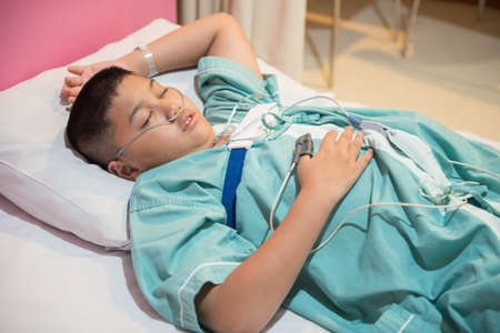 Asian boy wearing Sleep Apnea Diagnostic medical device Kit. Sleep Lab Test.の写真素材