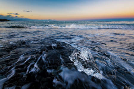 Ice rock on the black sand beach at Diamond Beach, Iceland Summer.