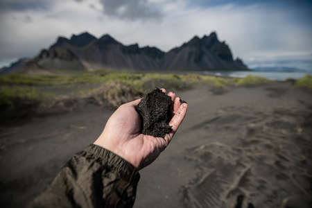 Black sand on hand and Vestrahorn Background ,Iceland Summer.の写真素材