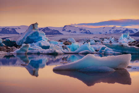 Icebergs in Jokulsarlon glacier lagoon. Vatnajokull National Park, Iceland Summer. Midnight Sun.
