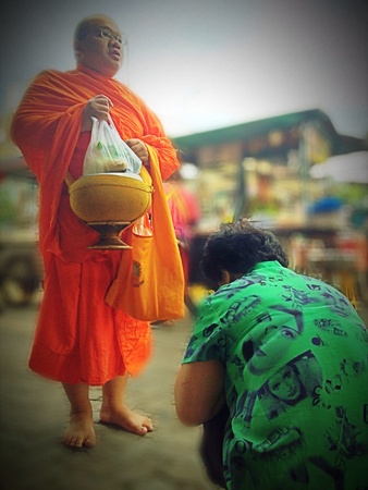 Old woman bowing to monk