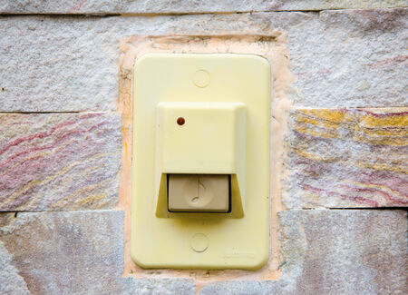 Old doorbell on a vintage stone wallの写真素材
