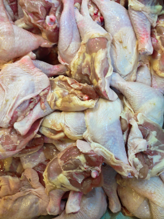 A lot of fresh raw chicken thighの写真素材