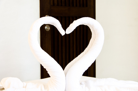 Decorate pair of clean towel on bed の写真素材