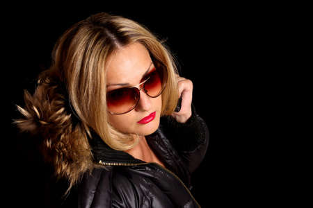 girl in sunglasses and jacket with fur hood