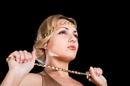 beautiful blonde in a Greek style keeps the chain in his hand 