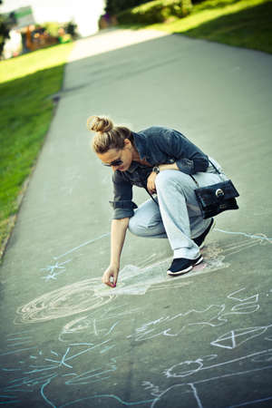 Drawing chalk on asphalt の写真素材