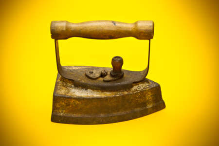 old iron on a yellow backgroundの写真素材