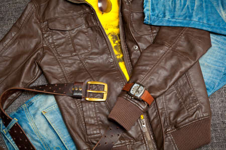 leather jacket, jeans with a belt, shirt, watches and sunglassesの写真素材