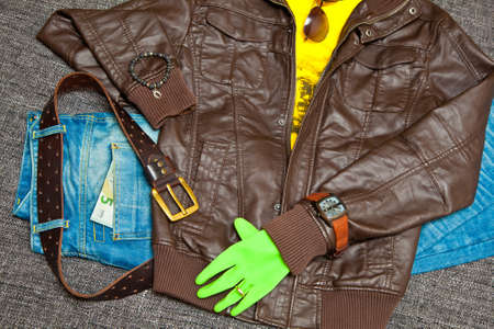 leather jacket, T-shirt, jeans with a leather belt, watches, bracelets, sunglasses and gloves. Banknote 5 Euroの写真素材