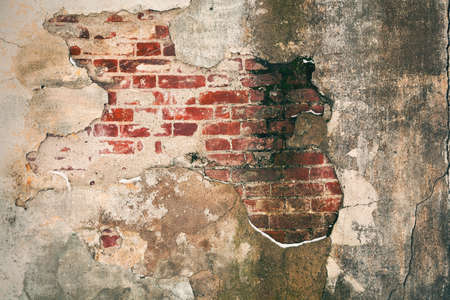 Old brick wall with peeling plaster. Grunge background - empty space for the designer fantasies. Old wall, rough detailed surface. place for text or imageの写真素材