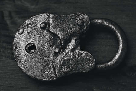 Vintage padlock close-up view from above. The old granary handmade hinged lock.の写真素材
