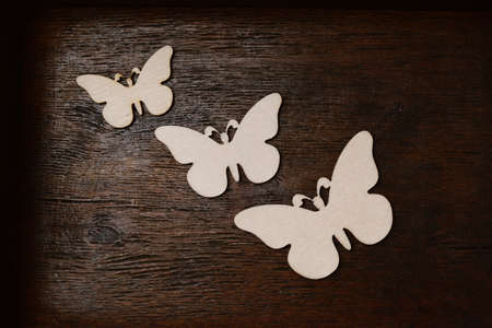 wooden butterfly on an old wooden backgroundの写真素材