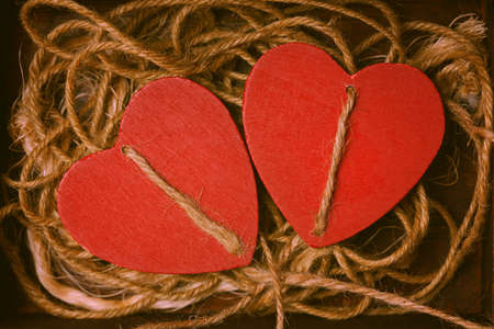 Two red hearts intertwined twine. Romantic backgroundの写真素材