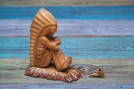 American Indian with a pipe. Handmade of woodの写真素材