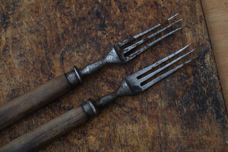 Old vintage forks on a wooden background, retro styleの写真素材
