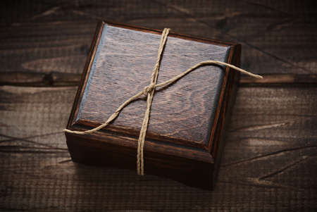 jewelry wooden box on wooden background. Gift box. Dark wooden casket