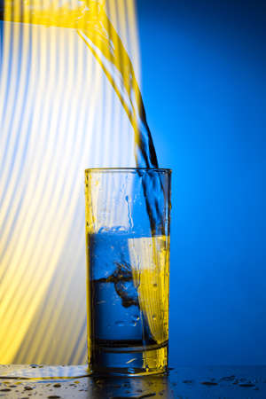 Water pours into the glass. Double exposure, creative receptionの写真素材