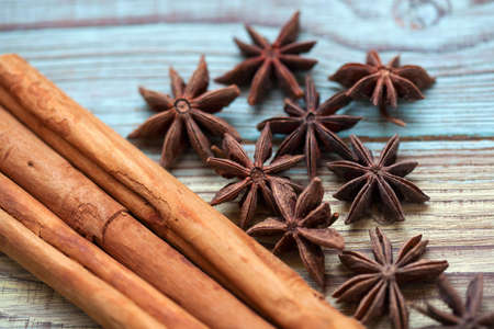 Cinnamon sticks and aniseed stars close up on a wooden tableの写真素材