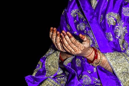 Asian muslim girl praying for Allah muslim god, Hands of muslim girl praying, wearing traditional clothes on black background isolated.の写真素材
