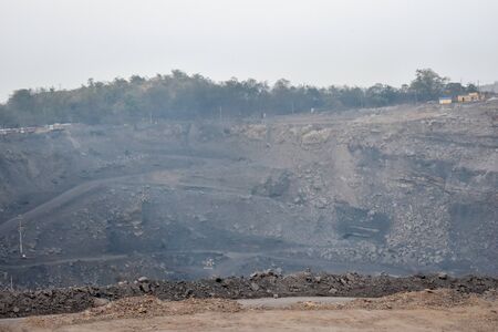 Samdi, Burdwan, West Bengal, India- February 19, 2019: Coal loading process by JCB and trucks in a...