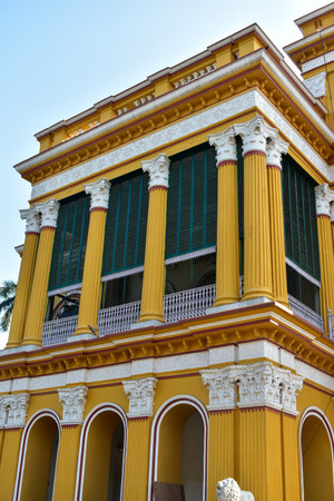 The image showcases Kathgola Palace, a grand colonial-era building in Murshidabad, West Bengal, India. This three-story yellow structure features a historic landmark, highlightingの写真素材