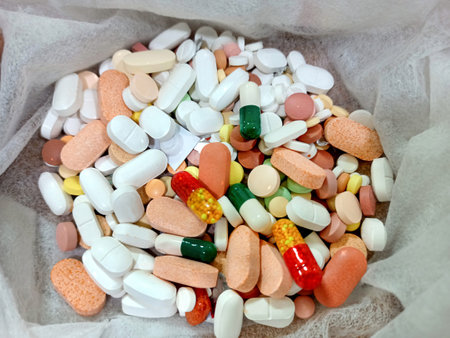Pictures of many colorful tablets & capsules kept in tissue paper in open condition.の写真素材