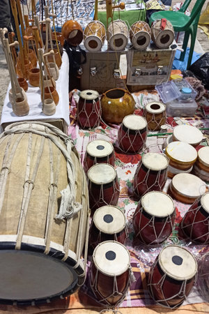 Kolkata, West Bengal, India - August 26, 2021; A scene from a musical instrument shop at the Calcutta Art Fair in India where a vendor was displaying a variety of handmade musical instruments made of wood and leather.の写真素材
