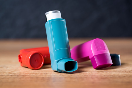 Various asthma inhalers on a wooden tableの写真素材