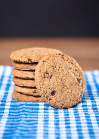 Delicious cookies stacked on a wooden tableの写真素材