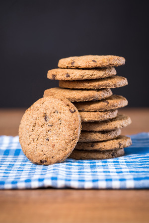 Delicious cookies stacked on a wooden tableの写真素材