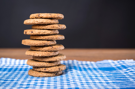 Delicious cookies stacked on a wooden tableの写真素材
